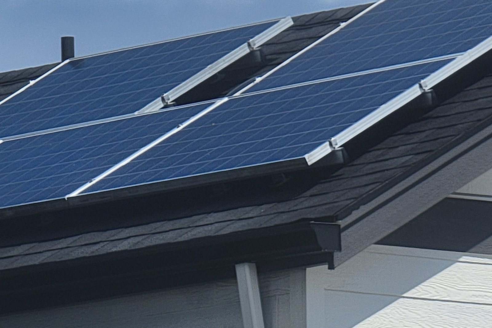 Close view of installed solar panels along a roofline