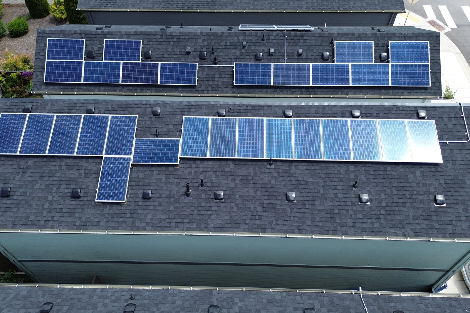 Overhead view of completed solar arrays on neighbouring homes